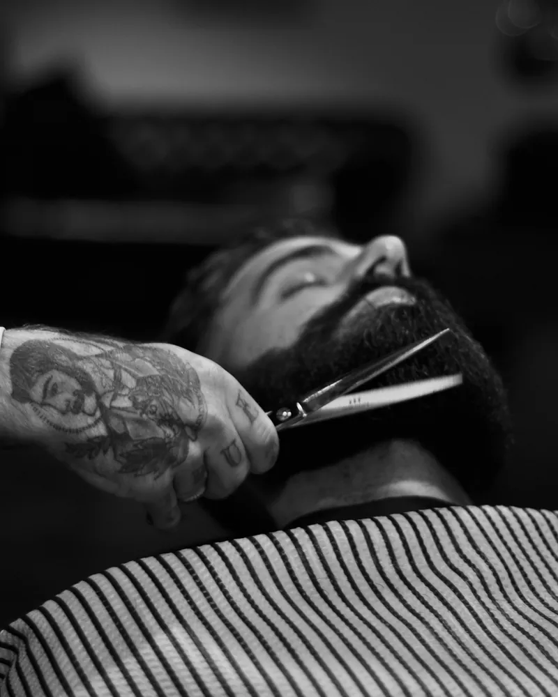 Black and white shot of a beard trim with scissors