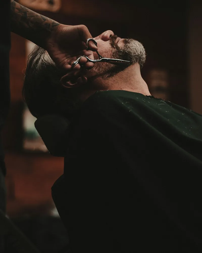 Client leaning back for a straight razor beard shave